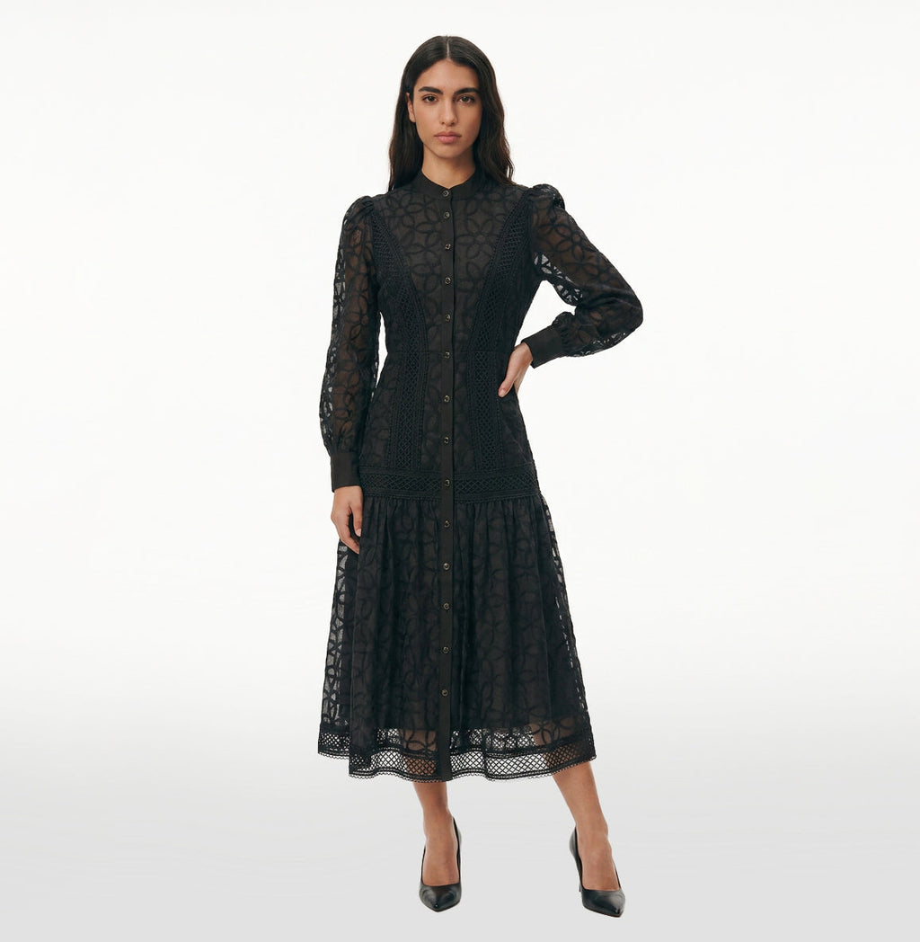 Woman wearing the Celeste Bloom Lace Midi Dress in black, featuring delicate lace, embroidered details and a modest feminine silhouette.