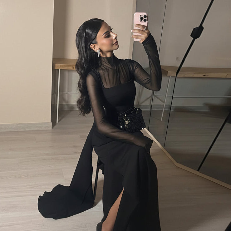 Modest high-neck black maxi dress with a sheer mesh top and side draping.