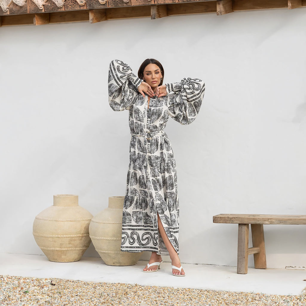 Woman wearing the Marina black modest maxi dress with long dramatic sleeves